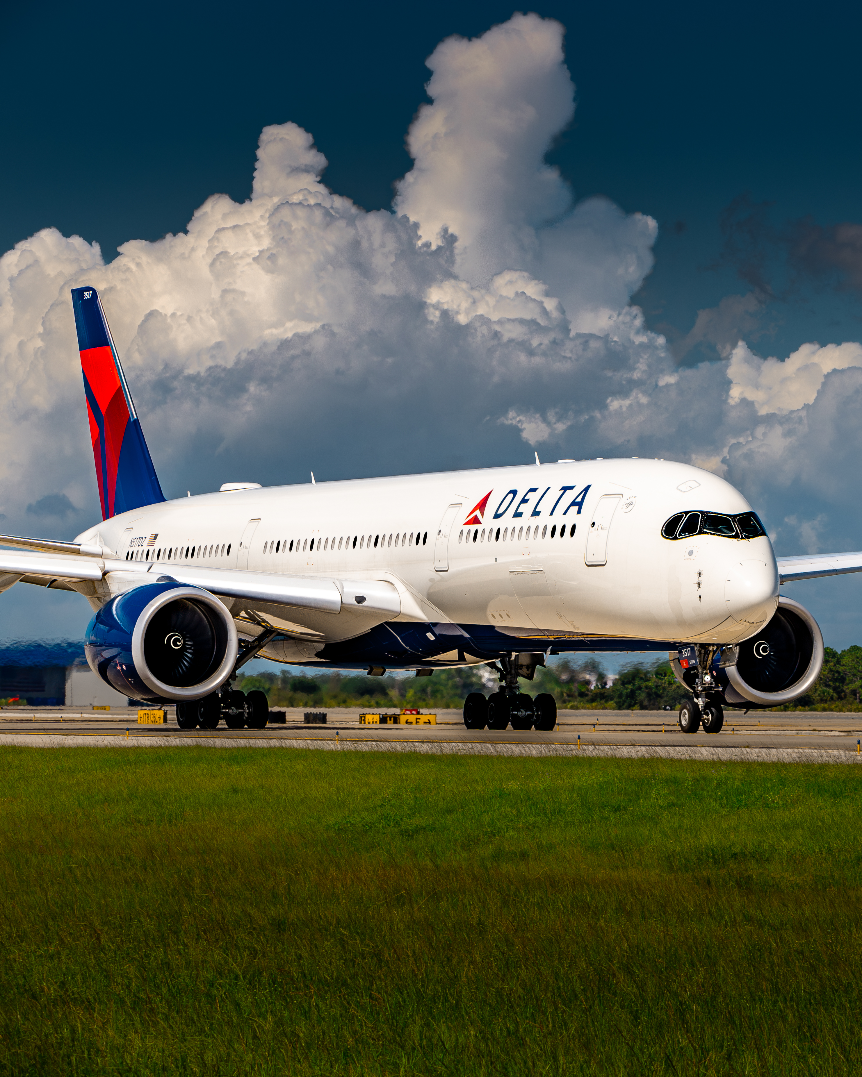 Delta Air Lines Airbus A350-900 on taxiway with storm backdrop