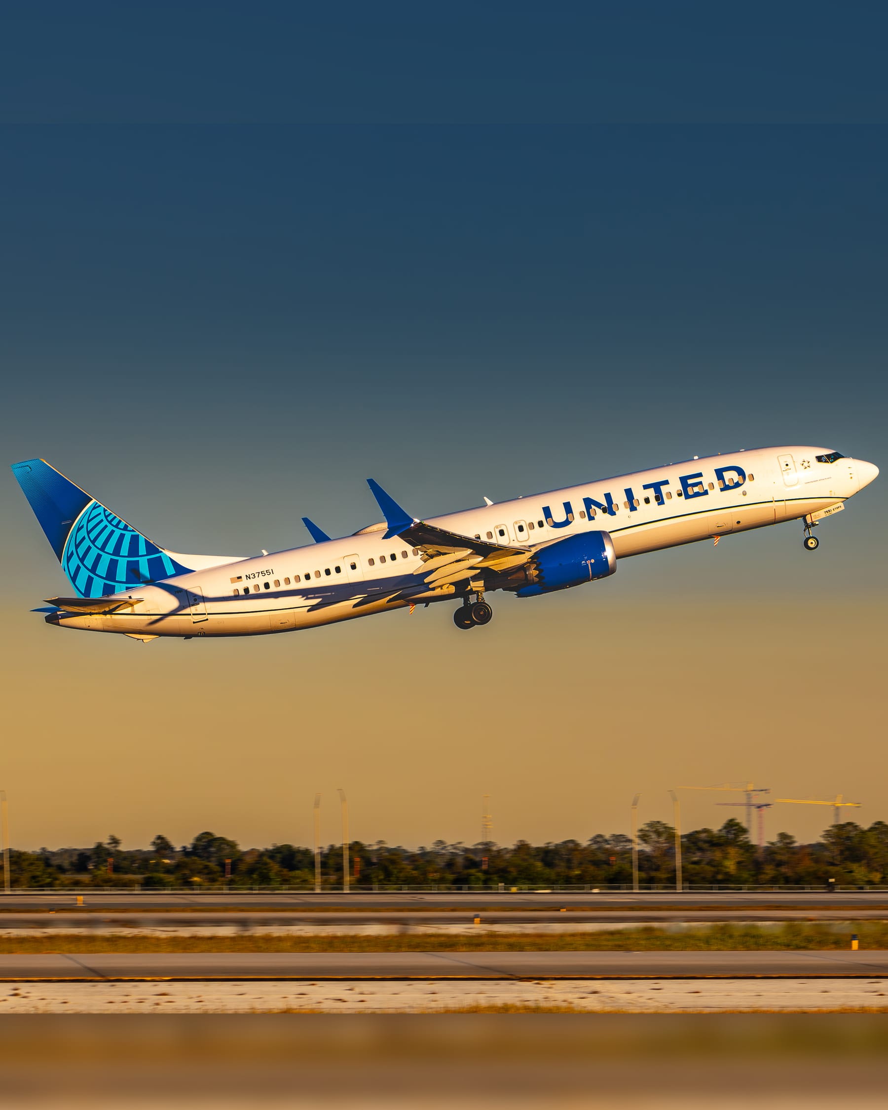 United Airlines Boeing 737-900 taking off at golden hour
