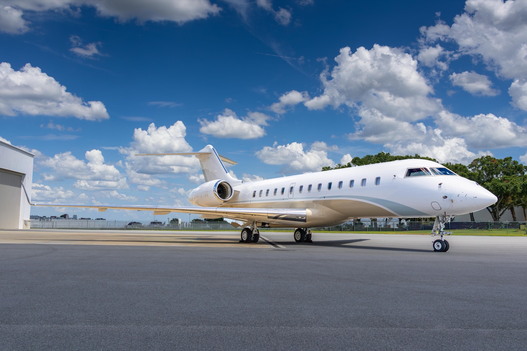 Bombardier Global 5000 side profile parked on the ramp near hangar