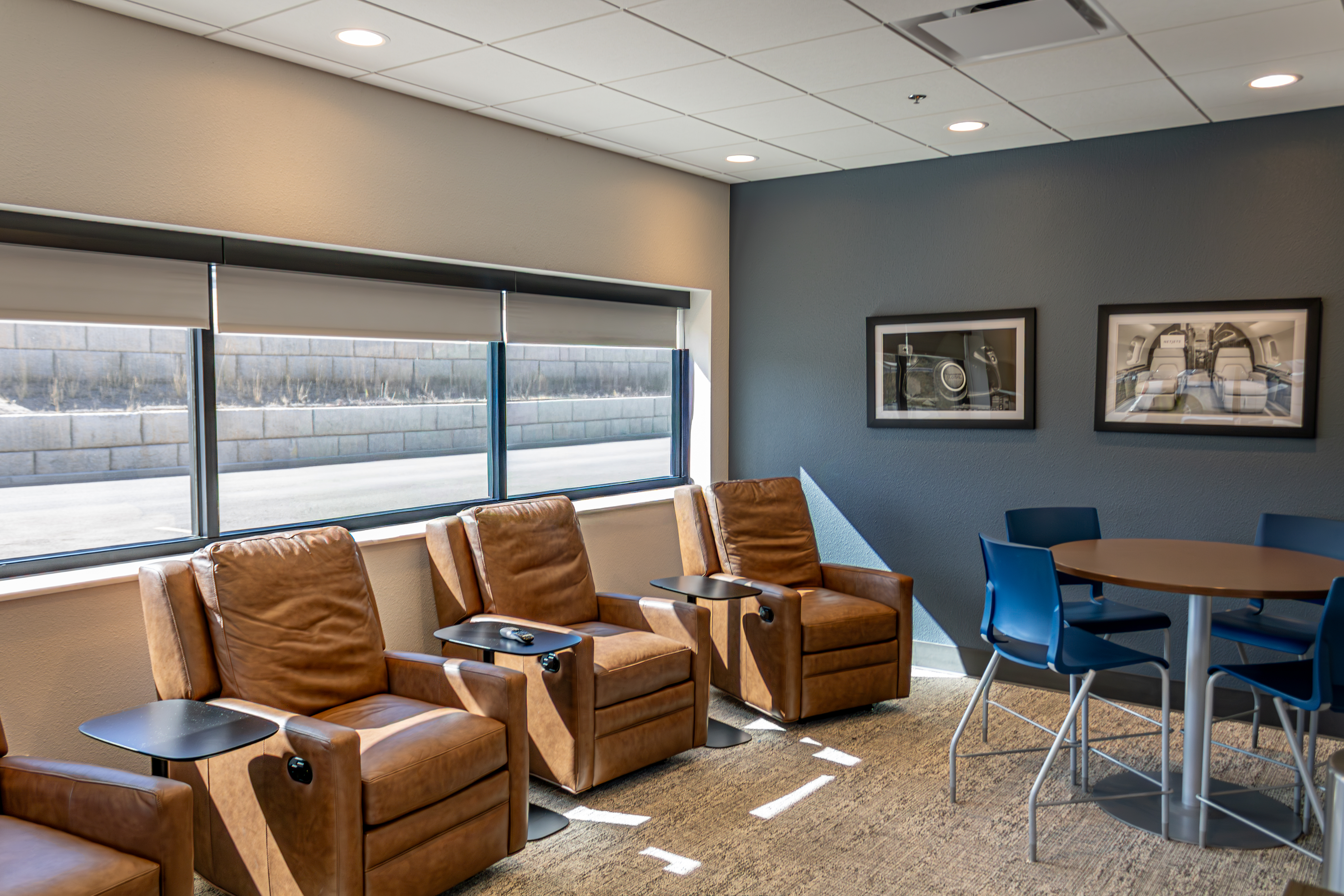 FBO lounge interior with leather recliners and aviation art